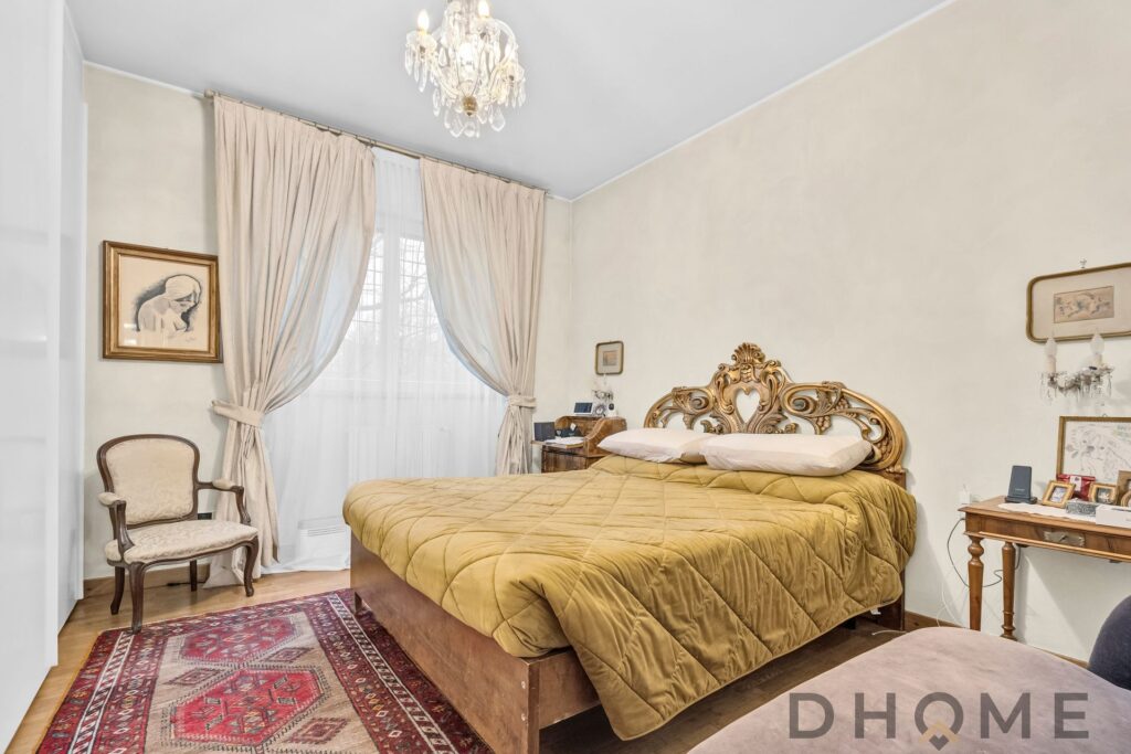 Letto matrimoniale con testiera in stile barocco, camera da letto elegante e raffinata.