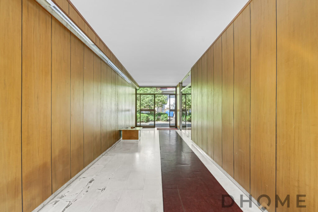 Porta d'ingresso con pareti in legno e design moderno, ingresso elegante e funzionale.