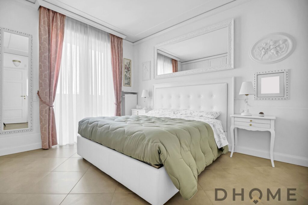 Camera da letto moderna con arredi raffinati e luce naturale.